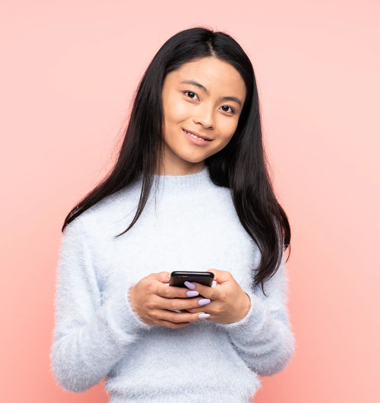 A smiling person exploring ideas on their phone